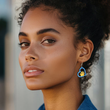 Woman wearing hand-painted birchwood paw heart earring with sterling silver fishhook wire