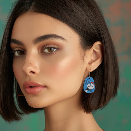 Woman wearing hand-painted birchwood "Butt Nuggets" chicken earring